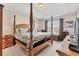 Comfortable main bedroom featuring tray ceiling, large bed, and ample natural light from the windows at 11925 Brookside Dr, Bradenton, FL 34211