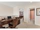Home office setup with desk, chair, and views into bedroom and bath; ideal for remote work or study at 11925 Brookside Dr, Bradenton, FL 34211