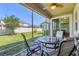 Cozy screened patio features comfortable seating and views of the fenced backyard and lush greenery at 11925 Brookside Dr, Bradenton, FL 34211