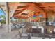 The open-air bar features mounted TVs, ceiling fans, and decorative fish suspended from the beautiful wood ceiling at 12020 Legacy Estates Blvd, Sarasota, FL 34238