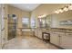 A luxury bathroom showcases a glass shower, soaking tub, and dual vanity with ample lighting at 12020 Legacy Estates Blvd, Sarasota, FL 34238
