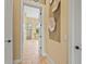 Hallway view leading into a bright bathroom with a glass-enclosed shower and soaking tub at 12020 Legacy Estates Blvd, Sarasota, FL 34238