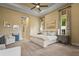 A spacious bedroom features neutral tones, tray ceiling, and large windows for natural light at 12020 Legacy Estates Blvd, Sarasota, FL 34238