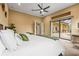 Bright bedroom features large glass doors that open to an enclosed patio with seating and a pool at 12020 Legacy Estates Blvd, Sarasota, FL 34238