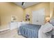 Bright bedroom with ceiling fan, white trim, closet, and a large bed with a blue comforter at 12020 Legacy Estates Blvd, Sarasota, FL 34238