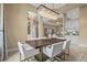 Dining room with modern chandelier and view of the home's open concept design at 12020 Legacy Estates Blvd, Sarasota, FL 34238