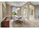 Dining room with modern chandelier, area rug and view of landscaped lawn at 12020 Legacy Estates Blvd, Sarasota, FL 34238