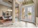 Inviting foyer with double doors, tile flooring, elegant lighting, and views into the dining room at 12020 Legacy Estates Blvd, Sarasota, FL 34238