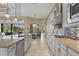 Open concept kitchen featuring a long island, stainless appliances and tile backsplash at 12020 Legacy Estates Blvd, Sarasota, FL 34238