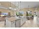 Spacious kitchen with island and stainless steel dishwasher overlooking the dining and living areas at 12020 Legacy Estates Blvd, Sarasota, FL 34238