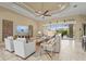 Spacious living room featuring tile flooring, tray ceilings, neutral décor, and ample natural light at 12020 Legacy Estates Blvd, Sarasota, FL 34238