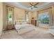 Main bedroom with large windows overlooking the lawn and tray ceiling at 12020 Legacy Estates Blvd, Sarasota, FL 34238