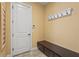 Mudroom featuring a white door, hooks for coats, and a built-in dark wood bench with drawers at 12020 Legacy Estates Blvd, Sarasota, FL 34238