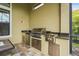 A stainless steel outdoor kitchen is equipped with granite countertops and built-in storage at 12020 Legacy Estates Blvd, Sarasota, FL 34238