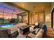 A screened-in patio with a pool, spa, fire pit, and comfortable seating offers outdoor relaxation at 12020 Legacy Estates Blvd, Sarasota, FL 34238