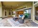 Covered outdoor patio with a ceiling fan, stylish furniture, and sliding doors leading to the interior at 12020 Legacy Estates Blvd, Sarasota, FL 34238