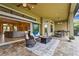 Spacious outdoor patio featuring a fire pit, comfortable seating, and a built-in outdoor kitchen at 12020 Legacy Estates Blvd, Sarasota, FL 34238