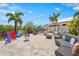 This outdoor patio features comfortable seating, patio games, and lush landscaping for the perfect community entertainment space at 12020 Legacy Estates Blvd, Sarasota, FL 34238
