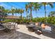 This outdoor patio features seating around fire pits and lush tropical landscaping for the perfect community entertainment space at 12020 Legacy Estates Blvd, Sarasota, FL 34238