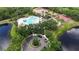 Aerial view of community pool, tennis courts, basketball court, and playground surrounded by lush landscaping at 12210 Goldenrod Ave, Bradenton, FL 34212