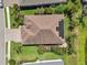 An aerial view showcases this lovely home with solar panels, lush landscaping, and a brick driveway at 12210 Goldenrod Ave, Bradenton, FL 34212
