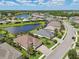 Areal community view featuring a tranquil lake, lush landscaping, and well-maintained homes at 12210 Goldenrod Ave, Bradenton, FL 34212