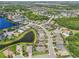 An aerial view displays this neighborhood with mature trees, tranquil ponds, and well-maintained streets at 12210 Goldenrod Ave, Bradenton, FL 34212