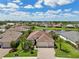 Beautiful aerial perspective showcases the home's prime location, manicured lawn, and nearby water feature at 12210 Goldenrod Ave, Bradenton, FL 34212