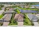 Aerial view of the home nestled between lush landscaping and a tranquil lake, showcasing community charm at 12210 Goldenrod Ave, Bradenton, FL 34212