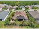 Aerial view of a home with solar panels, a screened patio, and landscaped yard at 12210 Goldenrod Ave, Bradenton, FL 34212