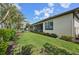 Spacious backyard with a well-manicured lawn, complemented by a screened lanai for outdoor entertaining at 12210 Goldenrod Ave, Bradenton, FL 34212