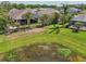 Aerial shot of the backyard with a fence, a pond, and landscaping at 12210 Goldenrod Ave, Bradenton, FL 34212