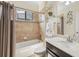 Cozy bathroom with shower-tub combination, dark cabinet, and bright natural light at 12210 Goldenrod Ave, Bradenton, FL 34212