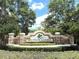 Entrance to Greyhawk Landing featuring a monument sign and lush, manicured landscaping at 12210 Goldenrod Ave, Bradenton, FL 34212