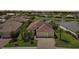 Charming home with three-car garage, brick driveway, lush landscaping, and a cozy front porch at 12210 Goldenrod Ave, Bradenton, FL 34212