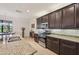 Stylish kitchen features stainless steel appliances, granite countertops, and dark wood cabinetry at 12210 Goldenrod Ave, Bradenton, FL 34212