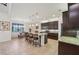 Bright kitchen featuring dark cabinets, granite counters, stainless appliances, and an island with barstool seating at 12210 Goldenrod Ave, Bradenton, FL 34212