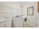 Convenient laundry room with sink, cabinets, and modern washer and dryer at 12210 Goldenrod Ave, Bradenton, FL 34212