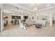 Open-concept living room featuring a modern kitchen, lounge seating, and dining area at 12210 Goldenrod Ave, Bradenton, FL 34212