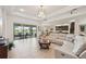 Open-concept living room with tile floors, large windows, and modern furnishings at 12210 Goldenrod Ave, Bradenton, FL 34212