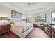 Well-lit main bedroom with dark hardwood floors, large window, and ceiling fan at 12210 Goldenrod Ave, Bradenton, FL 34212