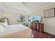 This is a cozy main bedroom with a large TV, nice decor and hardwood floors at 12210 Goldenrod Ave, Bradenton, FL 34212