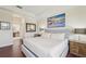 Bright main bedroom with hardwood floors featuring a large painting above the headboard at 12210 Goldenrod Ave, Bradenton, FL 34212