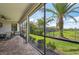 Large screened lanai with lush backyard, ceiling fan, and view of pond at 12210 Goldenrod Ave, Bradenton, FL 34212