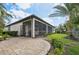 Inviting patio space connected to a screened lanai and lush backyard, ideal for outdoor entertaining at 12210 Goldenrod Ave, Bradenton, FL 34212