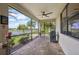 Relaxing screened patio with outdoor grill, ceiling fan, and view of the pond and backyard at 12210 Goldenrod Ave, Bradenton, FL 34212