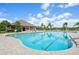 Community pool with lounge chairs and umbrellas, ideal for relaxation and recreation at 12210 Goldenrod Ave, Bradenton, FL 34212