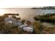 Aerial view showcasing waterfront homes with private docks and a pool, set against a scenic water backdrop at 1479 Bay Point Dr, Sarasota, FL 34236
