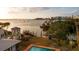 Beautiful aerial view of a home with a pool and boat dock, offering direct access to scenic waters at 1479 Bay Point Dr, Sarasota, FL 34236