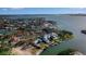 Magnificent waterfront estate featuring lush landscaping, a private pool, a boat dock, and scenic views of the bay and the city skyline at 1479 Bay Point Dr, Sarasota, FL 34236